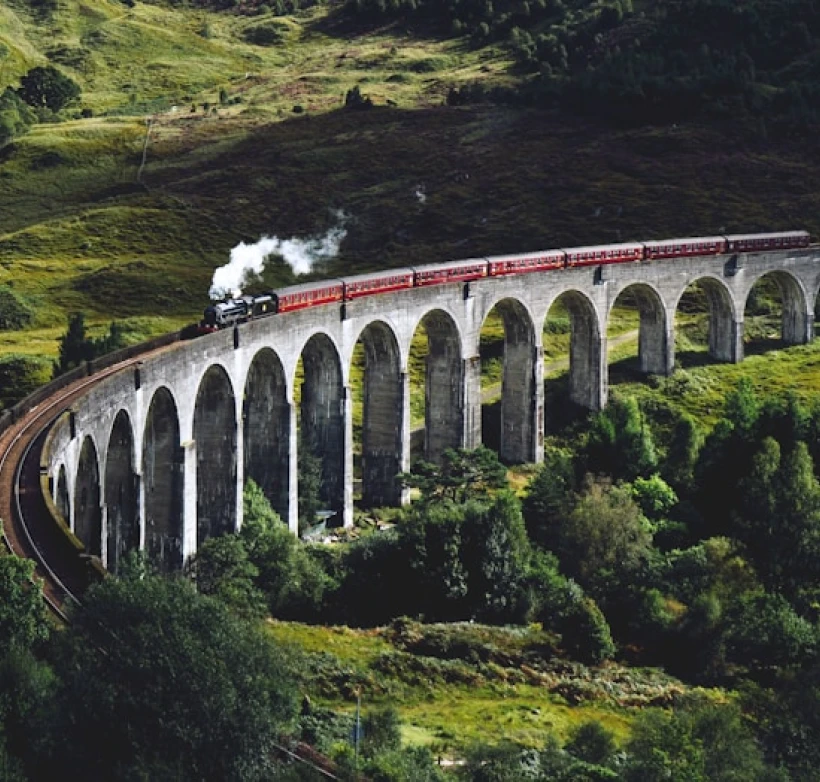 Passenger train crossing a viaduct in the European countryside