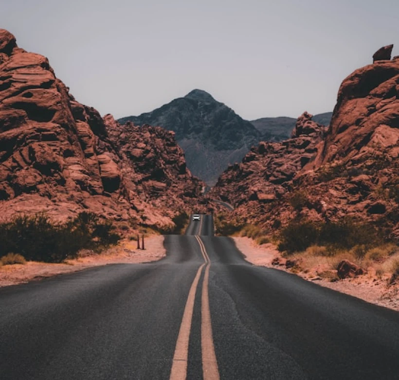 Empty road running through open country