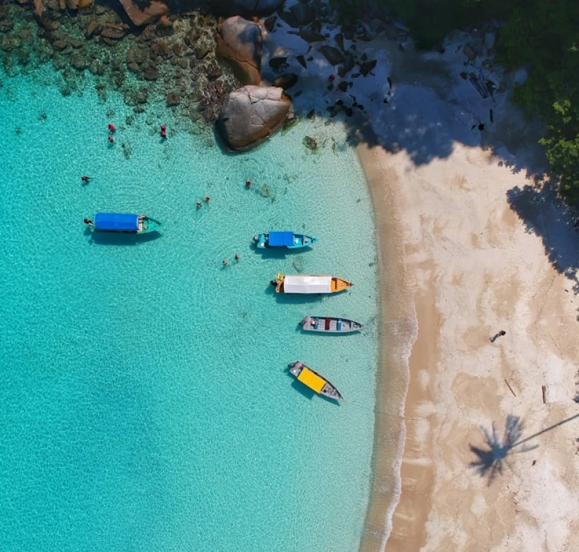 Aerial view of a coastline with moored boats